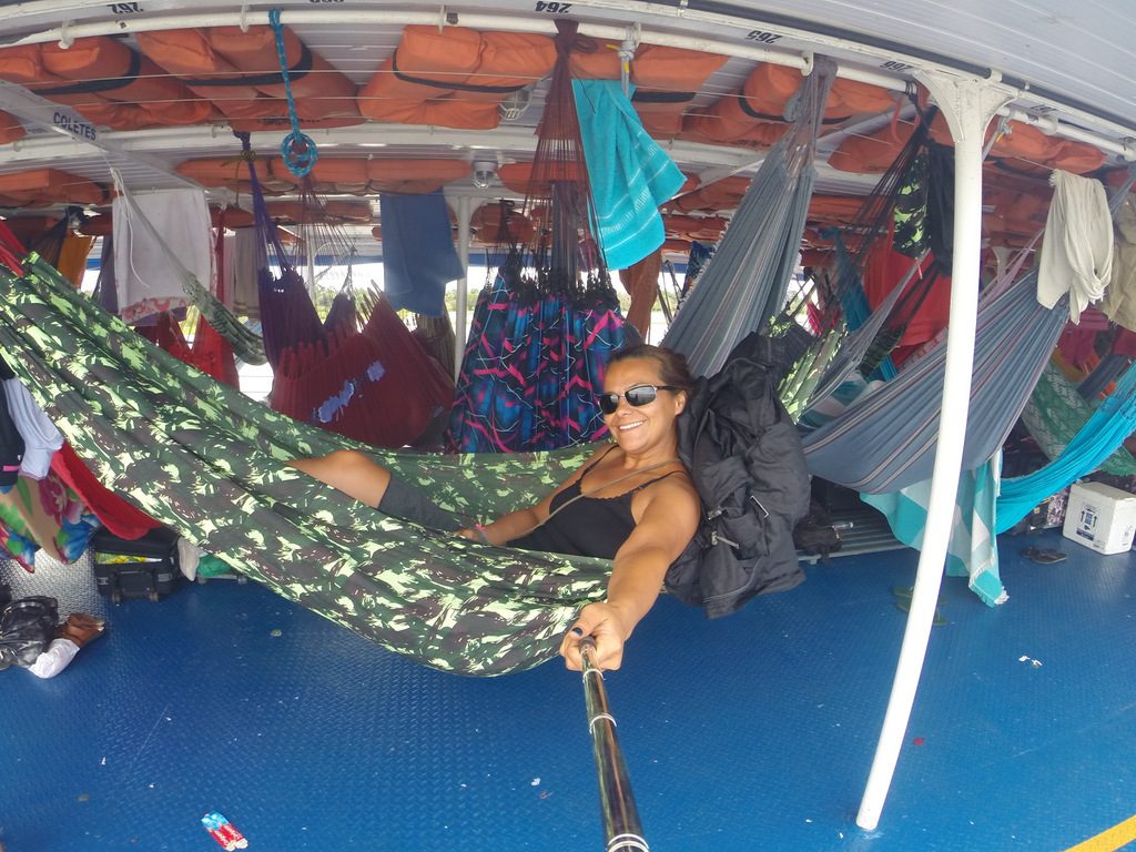 travel in amazon river by boat with hammock solo women